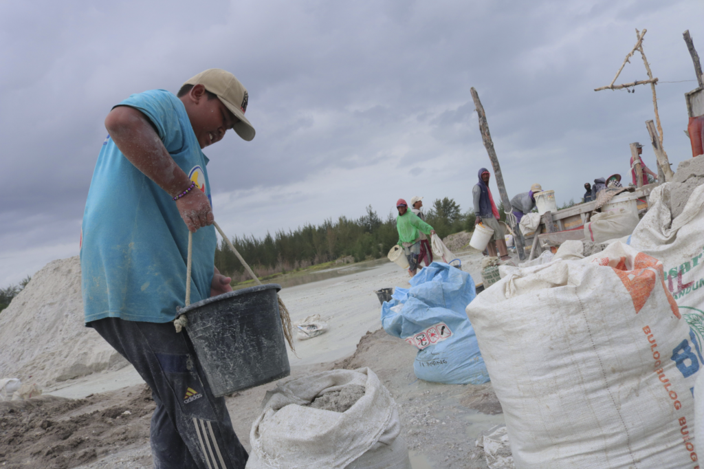 Rian (11) collects tin ore from tailing in Bangka Belitung